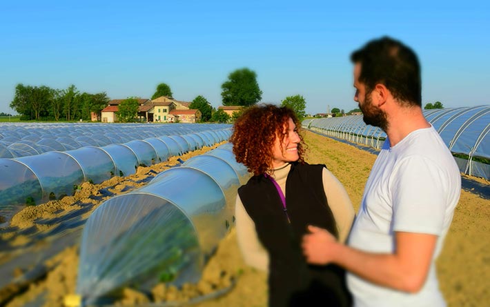 Zone Vocate: the cousins Daniele and Giulia Anceschi founders of the farm in front of greenhouses